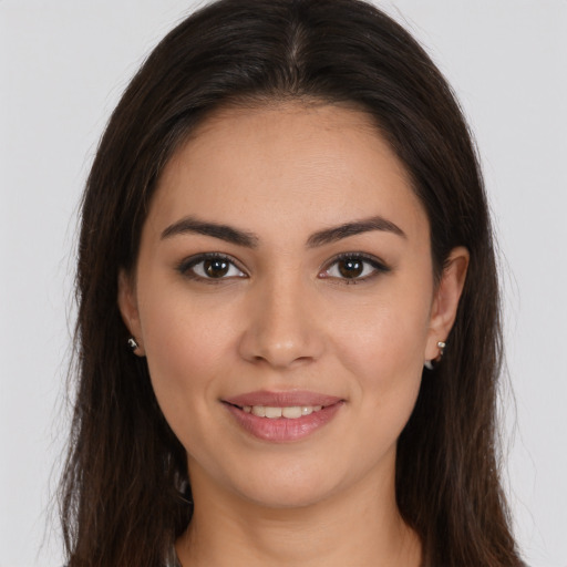 Joyful white young-adult female with long  brown hair and brown eyes