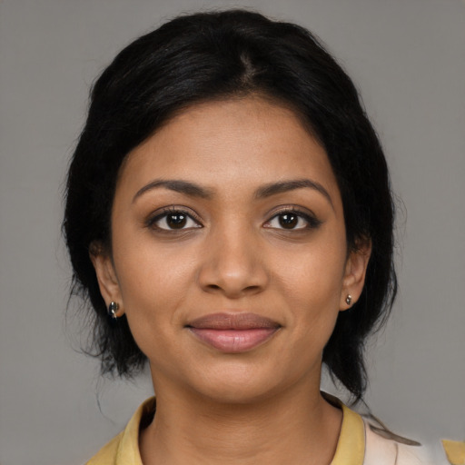 Joyful black young-adult female with medium  black hair and brown eyes