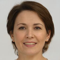 Joyful white adult female with medium  brown hair and brown eyes