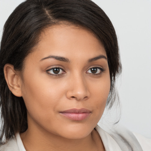 Joyful latino young-adult female with medium  brown hair and brown eyes