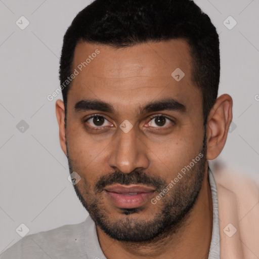 Joyful latino young-adult male with short  black hair and brown eyes