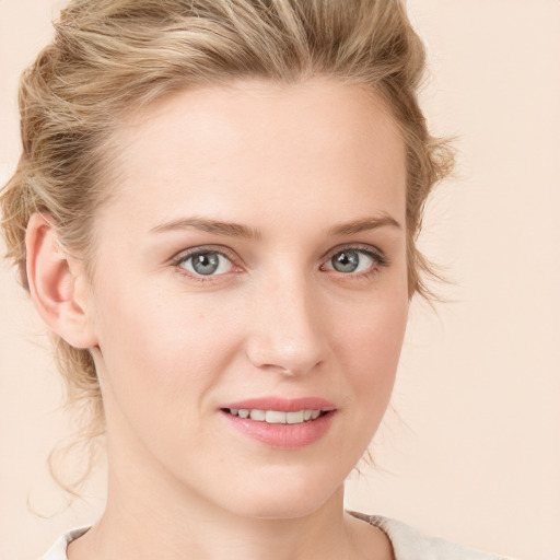 Joyful white young-adult female with medium  brown hair and blue eyes