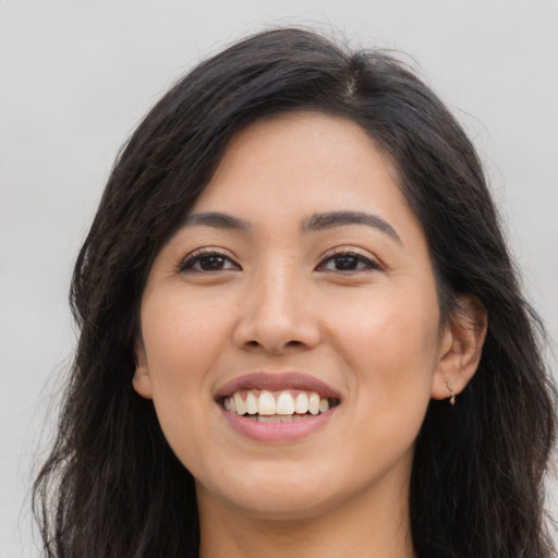 Joyful asian young-adult female with long  brown hair and brown eyes