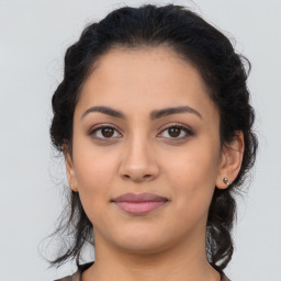 Joyful latino young-adult female with medium  brown hair and brown eyes