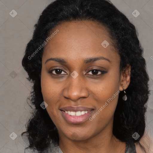 Joyful black young-adult female with long  black hair and brown eyes