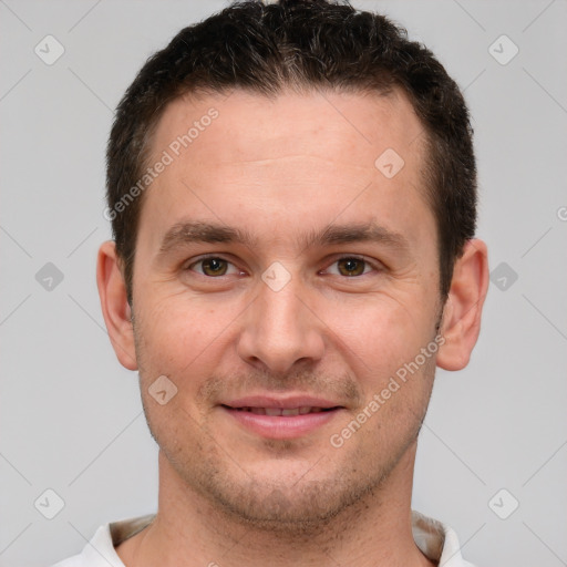 Joyful white young-adult male with short  brown hair and brown eyes