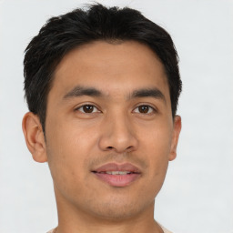 Joyful asian young-adult male with short  brown hair and brown eyes