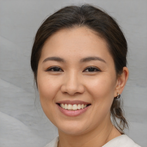 Joyful white young-adult female with medium  brown hair and brown eyes