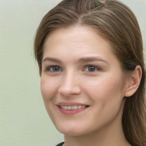 Joyful white young-adult female with long  brown hair and grey eyes