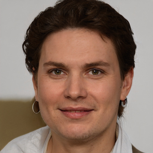 Joyful white adult male with short  brown hair and green eyes