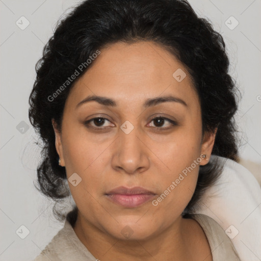 Joyful latino adult female with medium  brown hair and brown eyes