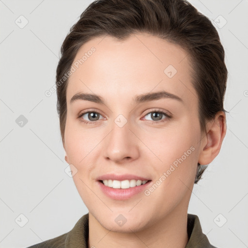 Joyful white young-adult female with short  brown hair and grey eyes