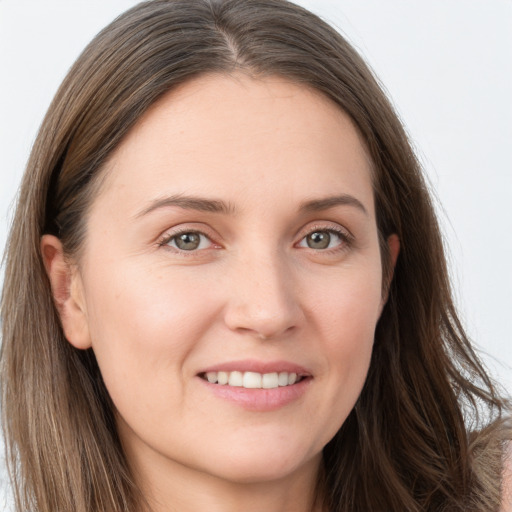 Joyful white young-adult female with long  brown hair and grey eyes