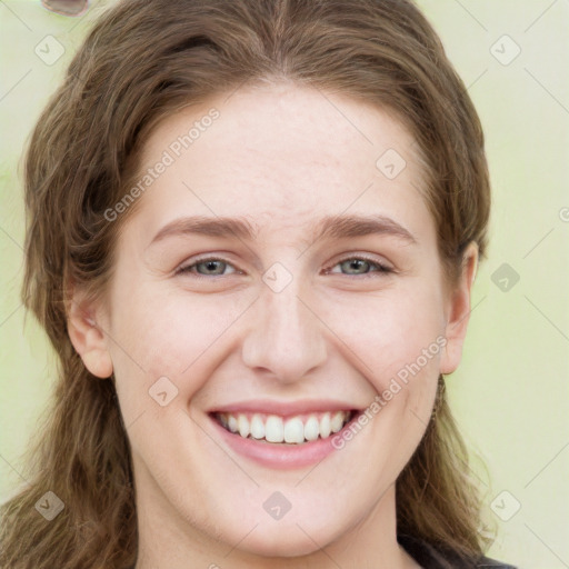 Joyful white young-adult female with long  brown hair and green eyes