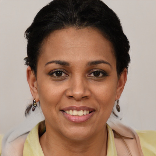 Joyful latino young-adult female with short  brown hair and brown eyes