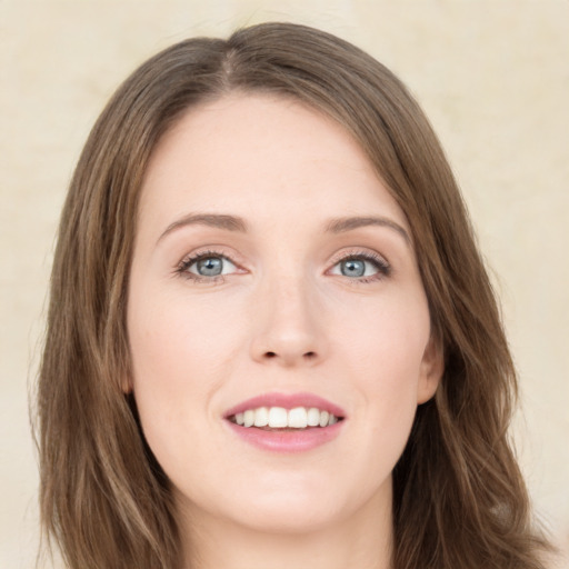 Joyful white young-adult female with long  brown hair and green eyes