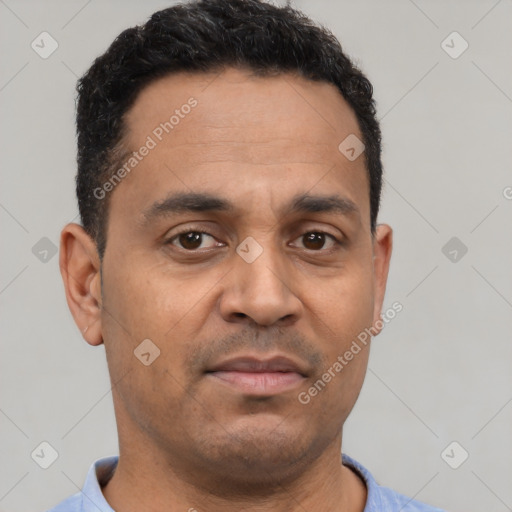 Neutral latino adult male with short  brown hair and brown eyes