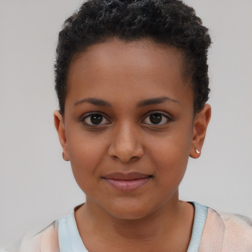 Joyful black child female with short  brown hair and brown eyes
