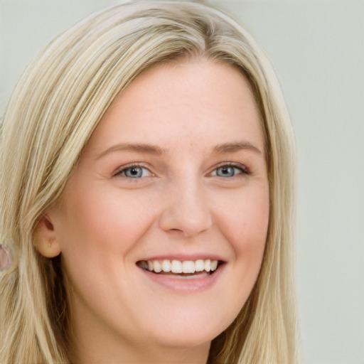 Joyful white young-adult female with long  blond hair and blue eyes