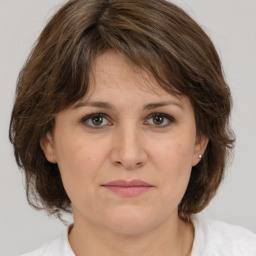 Joyful white adult female with medium  brown hair and brown eyes