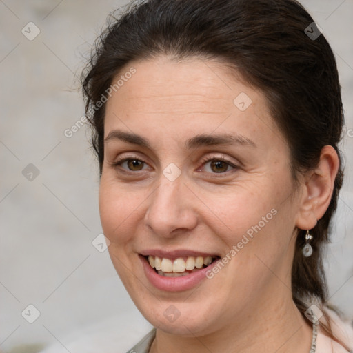 Joyful white adult female with medium  brown hair and brown eyes