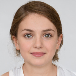 Joyful white young-adult female with medium  brown hair and green eyes