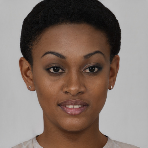 Joyful black young-adult female with short  brown hair and brown eyes