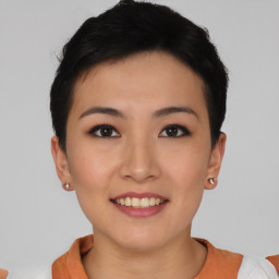 Joyful asian young-adult female with short  black hair and brown eyes