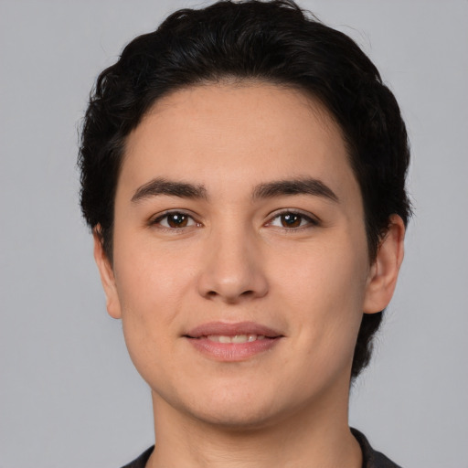 Joyful white young-adult male with short  black hair and brown eyes