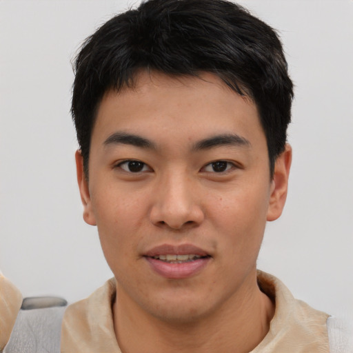 Joyful asian young-adult male with short  black hair and brown eyes