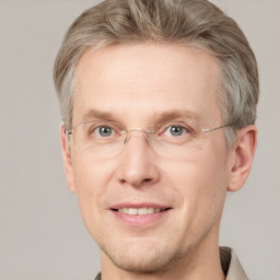 Joyful white adult male with short  brown hair and grey eyes