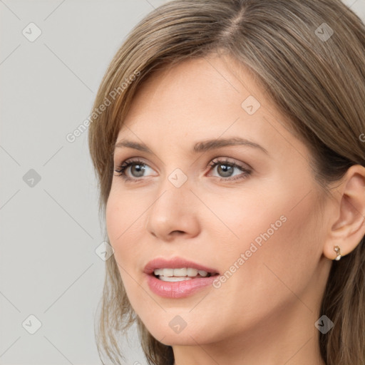 Joyful white young-adult female with long  brown hair and grey eyes