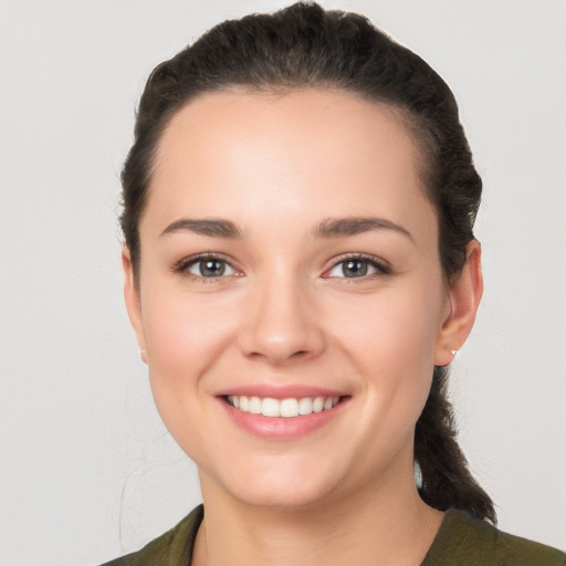 Joyful white young-adult female with medium  black hair and brown eyes