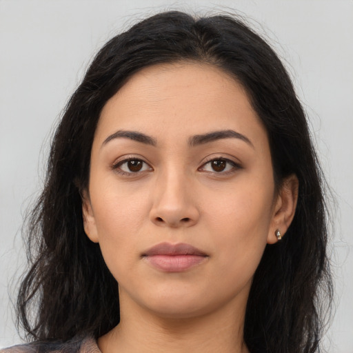 Neutral latino young-adult female with long  brown hair and brown eyes