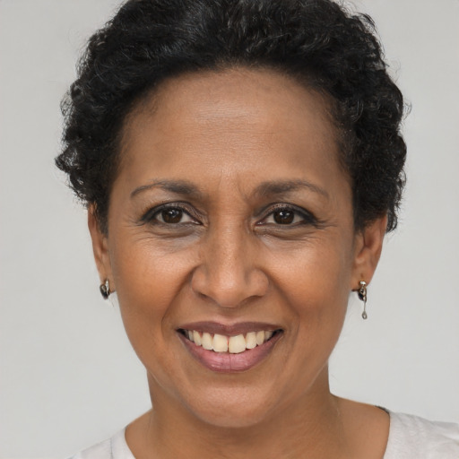 Joyful black adult female with short  brown hair and brown eyes