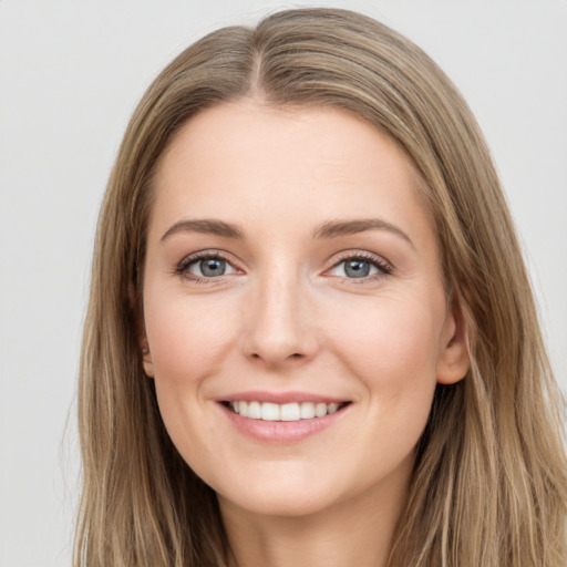 Joyful white young-adult female with long  brown hair and grey eyes