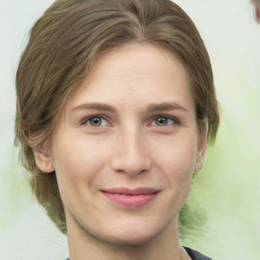 Joyful white young-adult female with medium  brown hair and green eyes