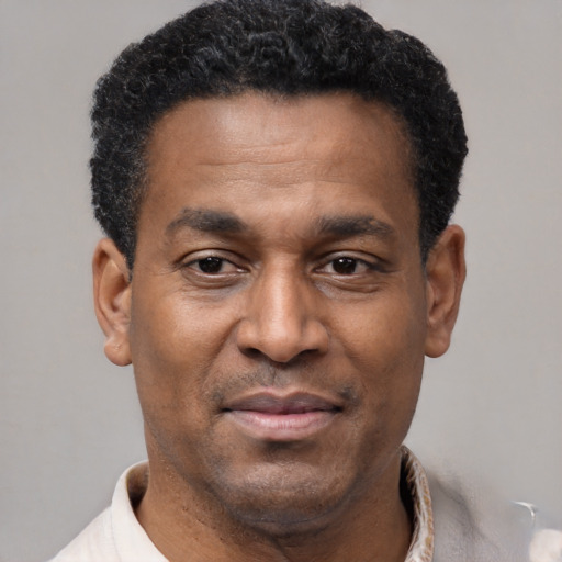 Joyful latino adult male with short  brown hair and brown eyes