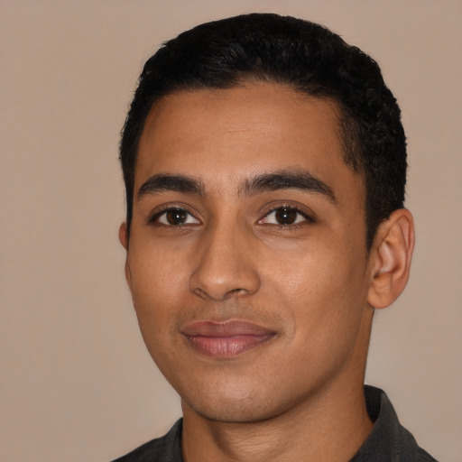 Joyful latino young-adult male with short  black hair and brown eyes