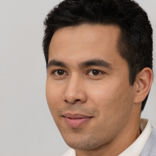 Joyful asian young-adult male with short  brown hair and brown eyes