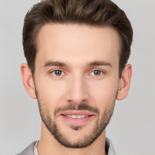 Joyful white young-adult male with short  brown hair and brown eyes