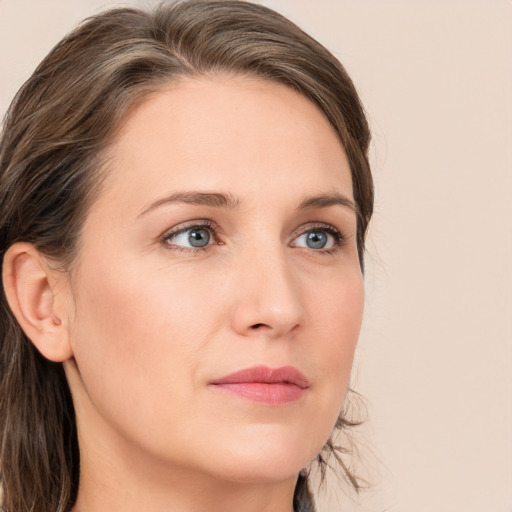 Neutral white young-adult female with long  brown hair and green eyes