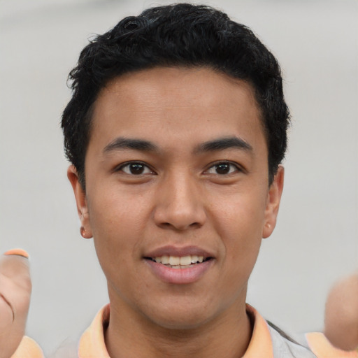 Joyful asian young-adult male with short  black hair and brown eyes