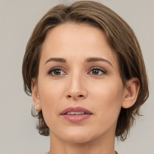 Joyful white young-adult female with medium  brown hair and brown eyes