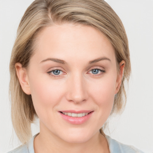 Joyful white young-adult female with medium  brown hair and blue eyes