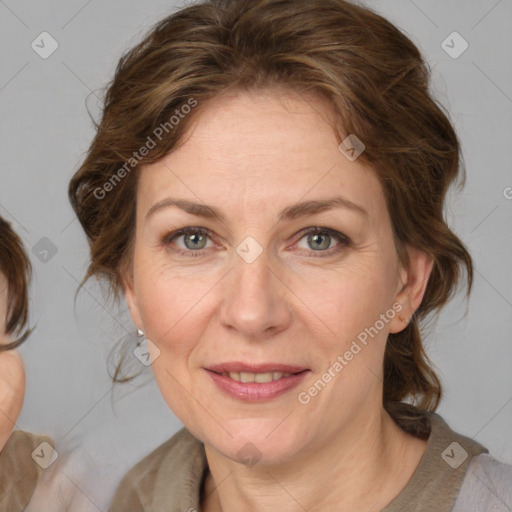 Joyful white adult female with medium  brown hair and blue eyes