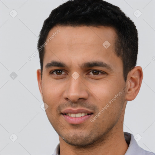 Joyful white young-adult male with short  black hair and brown eyes