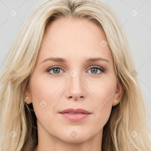 Joyful white young-adult female with long  brown hair and blue eyes