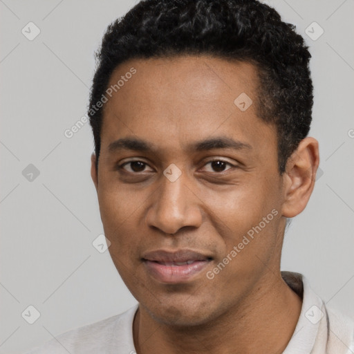 Joyful black young-adult male with short  black hair and brown eyes