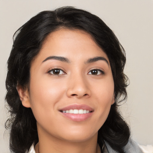 Joyful latino young-adult female with medium  black hair and brown eyes